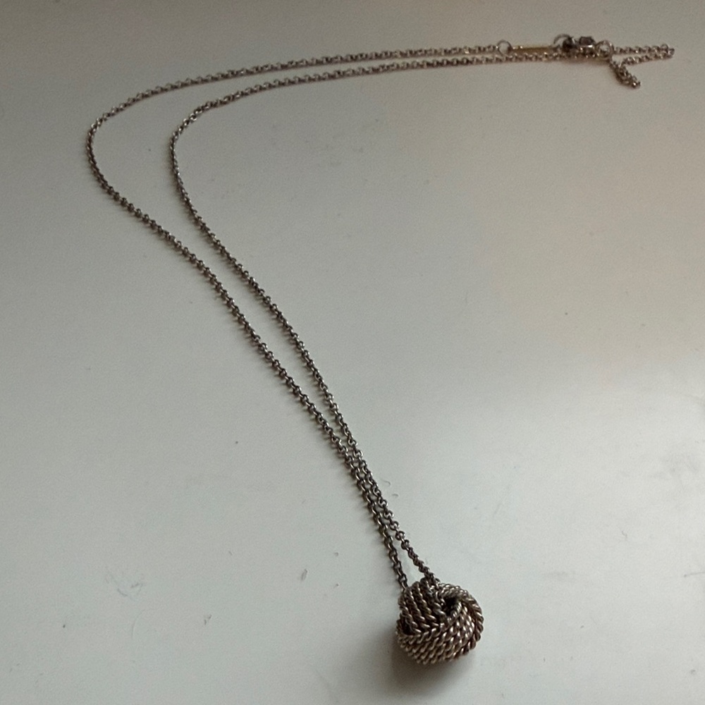 Tiffany and Co. Elegant Silver Knot Pendant Necklace
